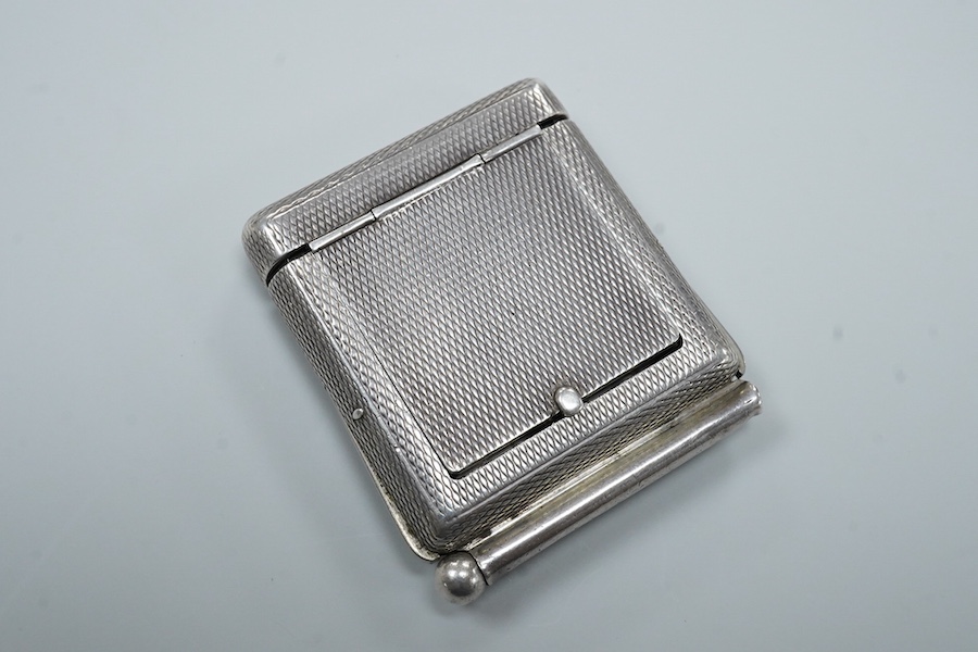 An early to mid 20th century engine turned 935 standard white metal combination travelling watch/pencil holder and notepad section, with Arabic dial, 42mm.